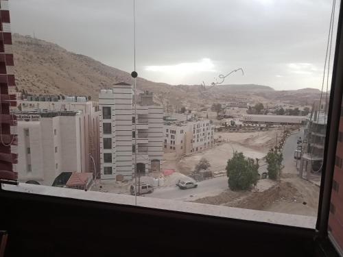 a view from a window of a city with buildings at cabin hotel in Ma‘ān