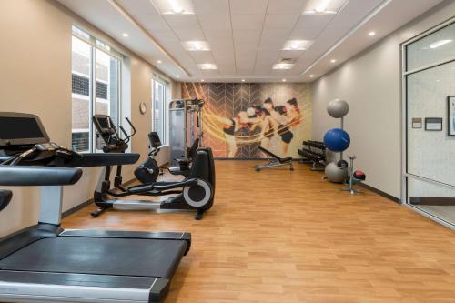 a gym with treadmills and elliptical machines at Hyatt Place Greenville Downtown in Greenville