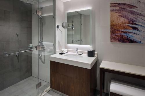 a bathroom with a sink and a shower at Hyatt House Jeddah Sari Street in Jeddah