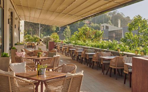 an outdoor restaurant with tables and chairs and a view at Hyatt Regency Addis Ababa in Addis Ababa