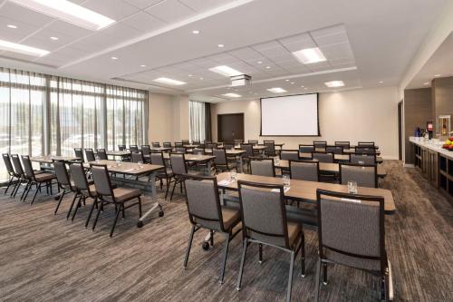 a conference room with tables and chairs and a whiteboard at Hyatt Place Virginia Beach Town Center in Virginia Beach