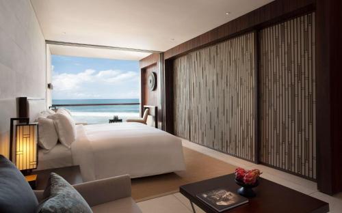 a bedroom with a bed and a view of the ocean at Alila Seminyak in Seminyak