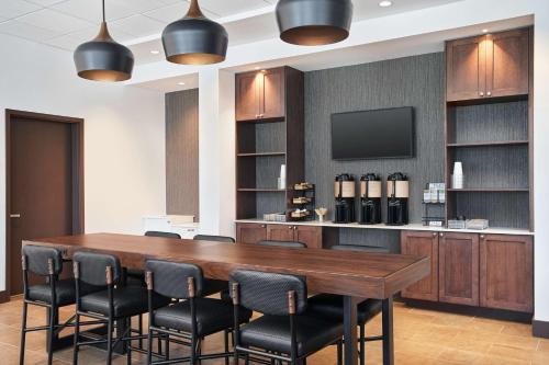 a conference room with a large wooden table and chairs at Hyatt Place Melbourne - Palm Bay - I-95 in Melbourne