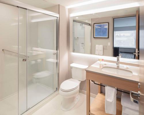 a bathroom with a toilet and a sink and a shower at Hyatt Place Moncton-Downtown in Moncton