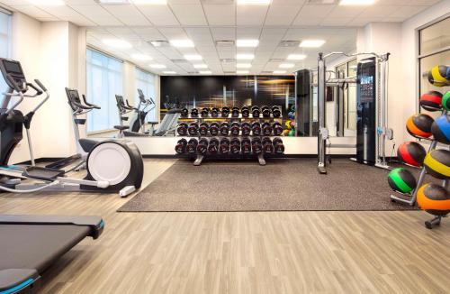 a gym with treadmills and machines in a room at Hyatt Place Moncton-Downtown in Moncton