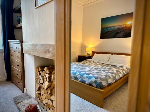 a bedroom with a bed and a fireplace at Victorian Cottage Like Charm with Modern Comforts in Bristol