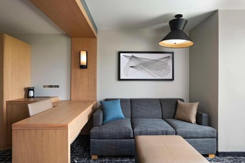 a living room with a couch and a table at Hyatt Place Austin Lake Travis/Four Points in Austin