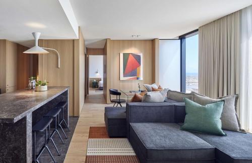 a living room and kitchen with a couch and a counter at Hyatt Centric Melbourne in Melbourne