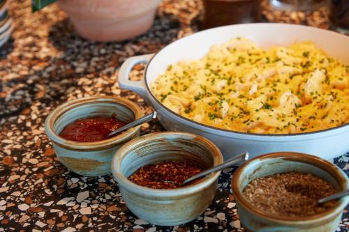 a table with a pot of food and some spices at Hyatt Centric Melbourne in Melbourne