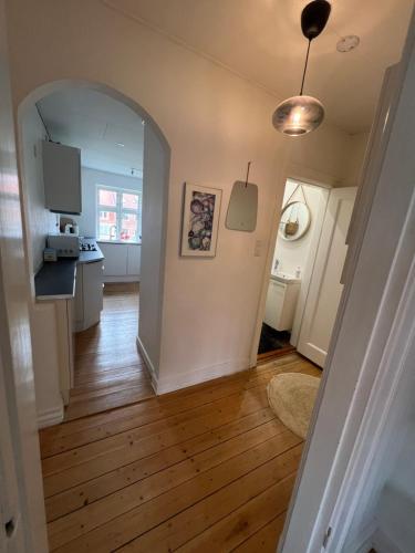 an open hallway with a kitchen and a dining room at Anna in Aalborg