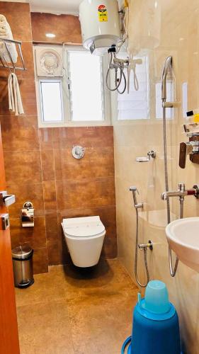 a bathroom with a toilet and a sink at HOTEL EDEN GARDEN in Āsansol