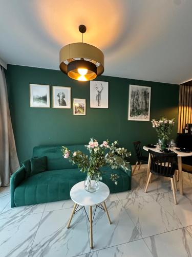 a living room with a green couch and a table at Blisko Gór Szyndzielnia in Bielsko-Biała