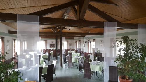 a dining room with tables and chairs in a building at Hotel Stadt Boizenburg in Boizenburg