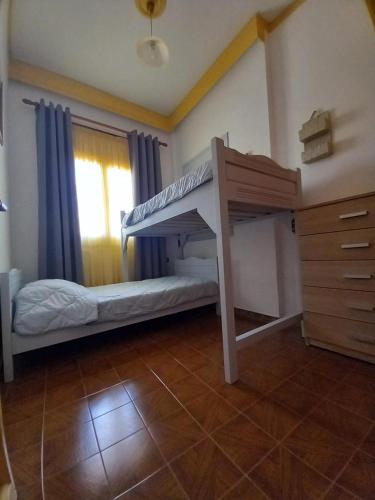 a bedroom with a bunk bed and a dresser at Agnanti house in Symi