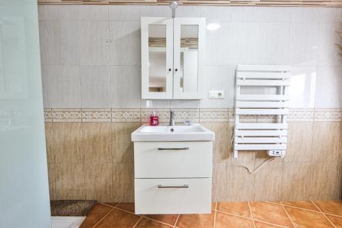 a bathroom with a white sink and a mirror at A Casa de Isaura in Camariñas