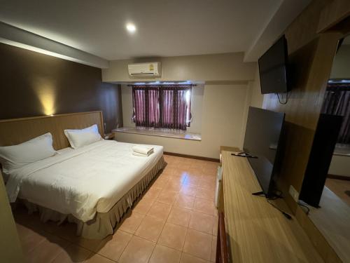 a hotel room with a bed and a television at P Chaweng in Chaweng