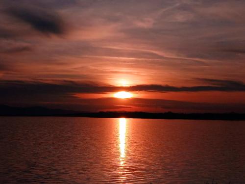 a sunset over a large body of water at Apartament DANI in Nysa