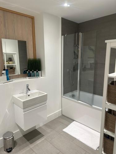 a bathroom with a sink and a shower at Central London penthouse apartment in London