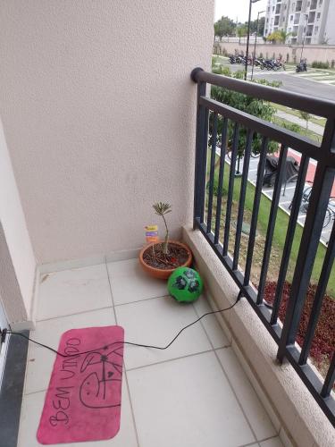 a rug on the floor of a balcony with a plant at Aconchego Hostel in Rio de Janeiro