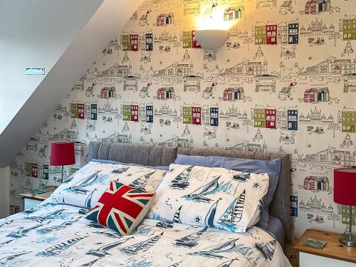 a bedroom with a bed with a wall covered in stickers at Iris Apartment in Stalham