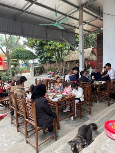 a group of people sitting at tables in a restaurant at The Garden Homestay Ninh Bình in Ninh Binh