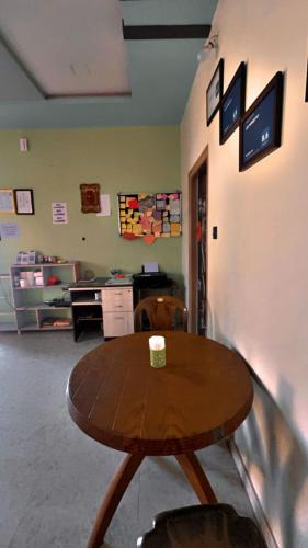 a wooden table in a room with a coffee cup on it at Lee home stay in Hampi
