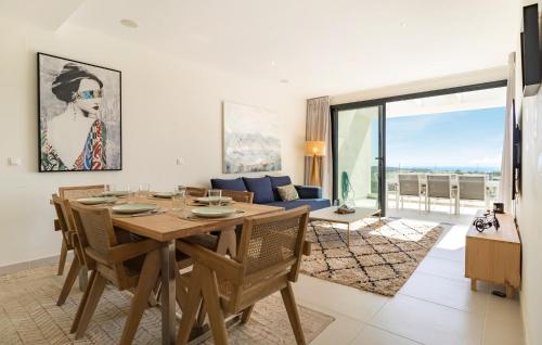 a dining room with a table and a couch at 3 Bedroom Amazing Apartment In Estepona in Estepona