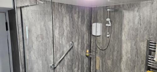 a bathroom with a shower with a shower at Amble Harbour retreats in Amble