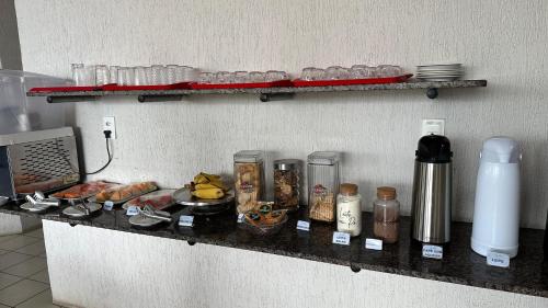 a counter with food and other items on it at Hotel Olho D'água - Baturité in Baturité