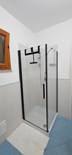 a shower with a glass door in a bathroom at Chia Sweet Home in Chia