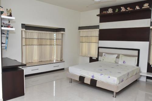a bedroom with a large bed in a room at MAHAMAYA HOME STAY in Mysore