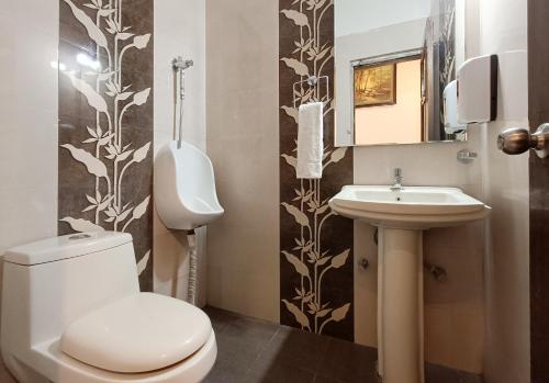a bathroom with a toilet and a sink at Hotel Katra Residency in Katra