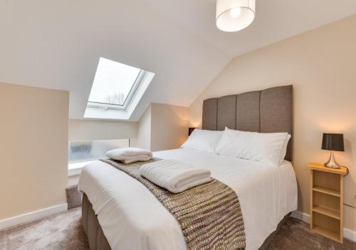 una camera con un grande letto e una finestra di Ardley Cottages a Waldingfield