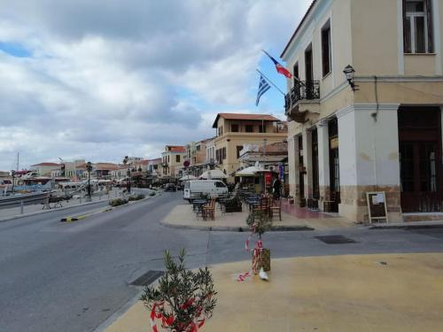 an empty street with christmas trees in a town at Aegina Port Apt 2-Διαμέρισμα στο λιμάνι της Αίγινας 2 in Aegina Town