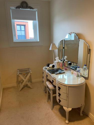 a room with a desk with a mirror on it at Ardawn House in Galway