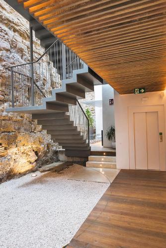 a staircase in a building with a white door at VillaMora Alfaros 35 FREE PARKING in Córdoba
