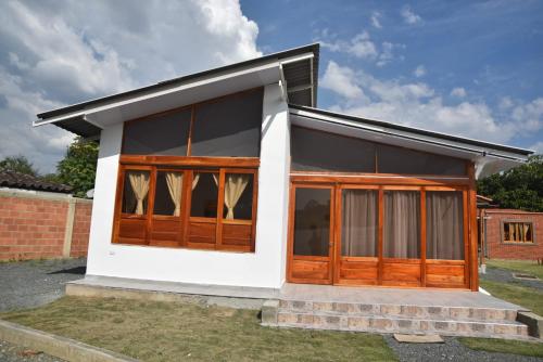 a small house with wooden doors and windows at Eco Cabañas Montana in Santa Helena
