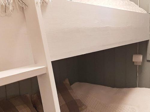 a white bunk bed with the bottom shelf of it at 7 person holiday home in SANDNES-By Traum in Forsand