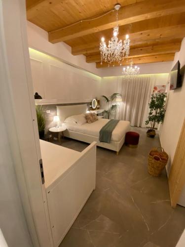 a bedroom with a bed and a chandelier at Atrium in Castellammare del Golfo