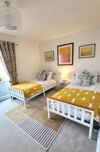 a bedroom with two beds and a couch at Insch House in Kincraig