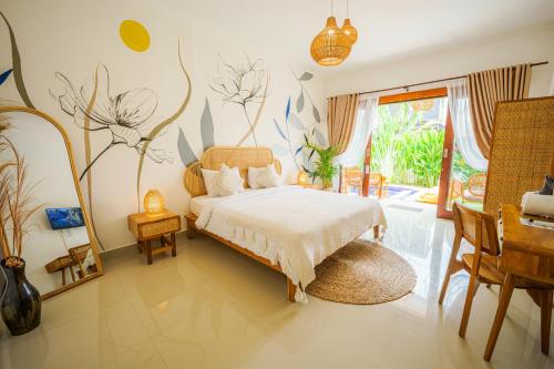 a bedroom with a bed and a table and chairs at Shortcut Breeze Guest House in Canggu
