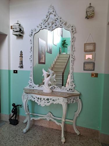 a dressing table with a mirror on top of it at Holidays at the Dock - Fiumicino Airport in Fiumicino