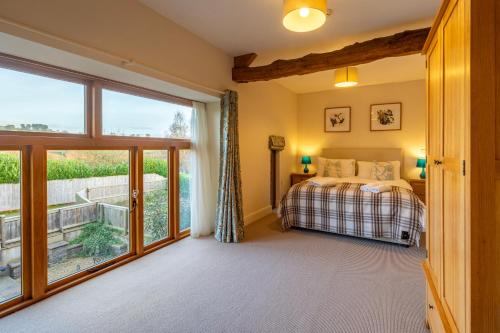 a bedroom with a bed and a large window at Marina View, Near Canal and Mountains in Brecon