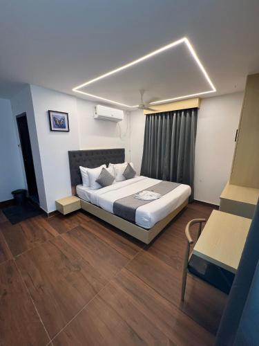 a bedroom with a bed in a room with wooden floors at Wild Wings Premium Hotel in Hyderabad