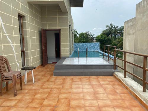 a balcony of a house with a pool at Aqua villa vedic village in kolkata