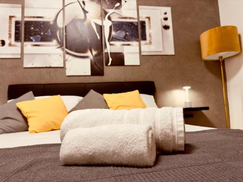 a bedroom with a bed with yellow pillows at G-house in Parma