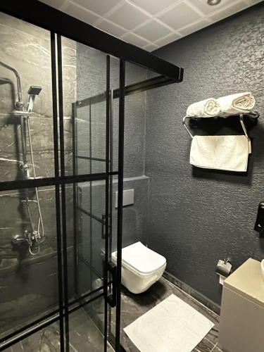 a bathroom with a toilet and a glass shower at DAYMONTH HOTEL in Istanbul