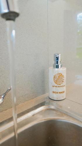 a bottle of dish washing liquid sitting next to a sink at Uma Rimbun Pool Villa by Uniquecations in Ubud
