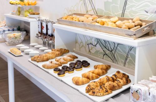 a bakery with several trays of pastries on display at Best Western Hotel Crimea in Turin