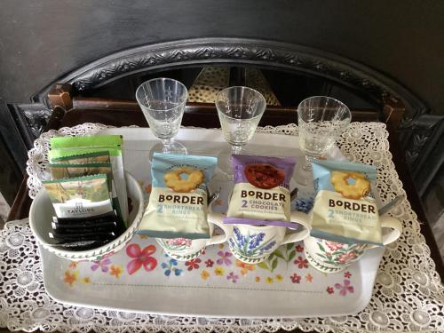 a tray with food and glasses on a table at Bryn Guest House in Conwy